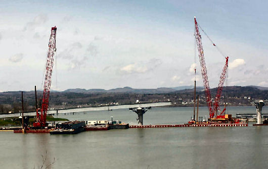 Mobile cranes on barges working on the new Lake Champlain bridge