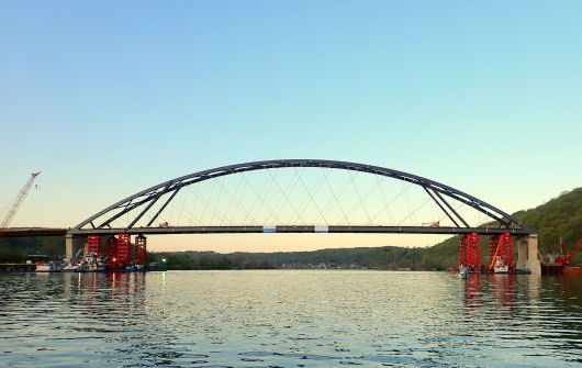 Wellsburg bridge span partly lowered onto piers