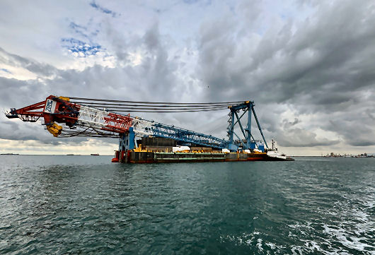 Mobile cranes on barges working on the new Lake Champlain bridge